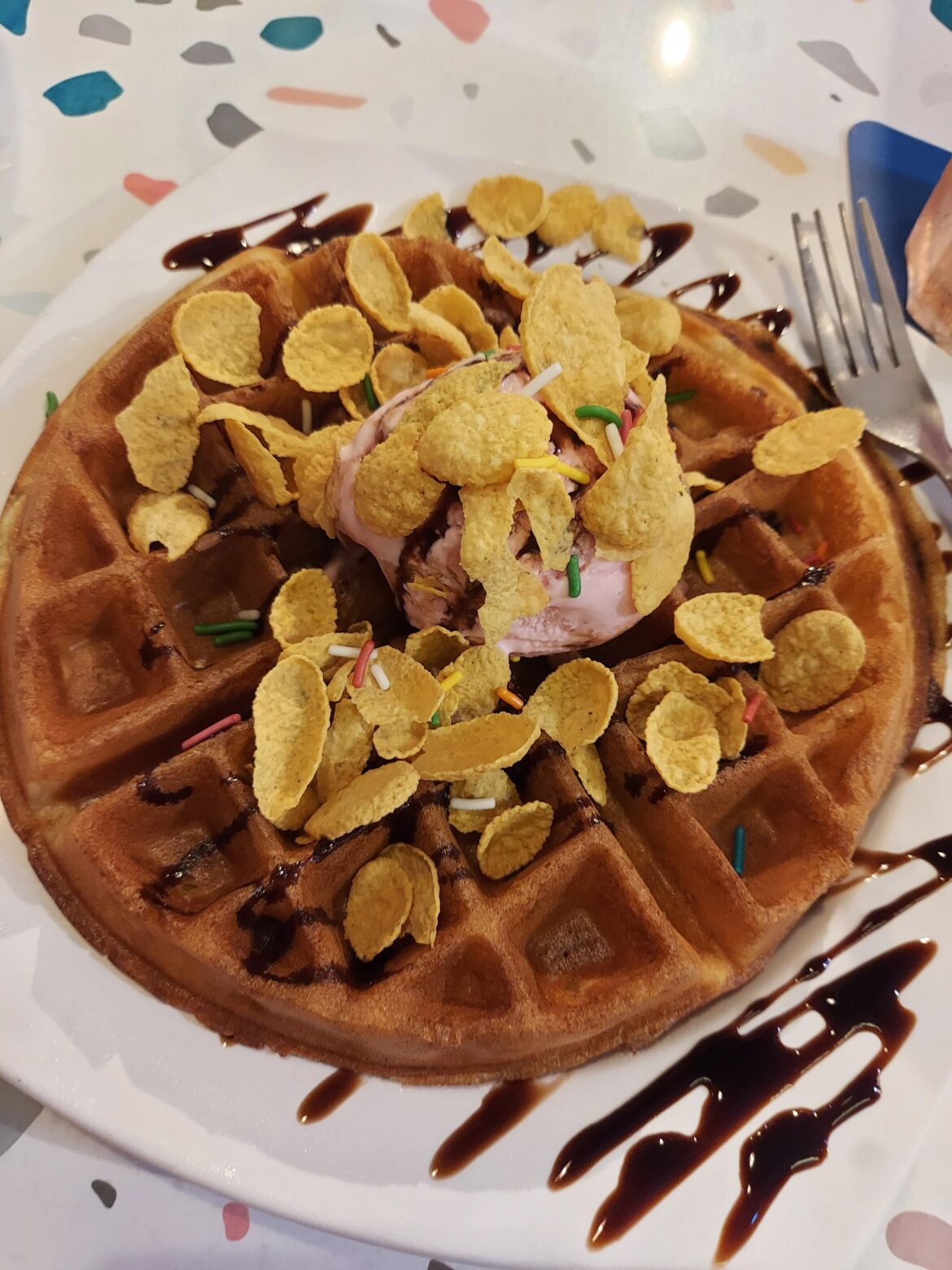 Ice cream on waffle, topped with cornflakes