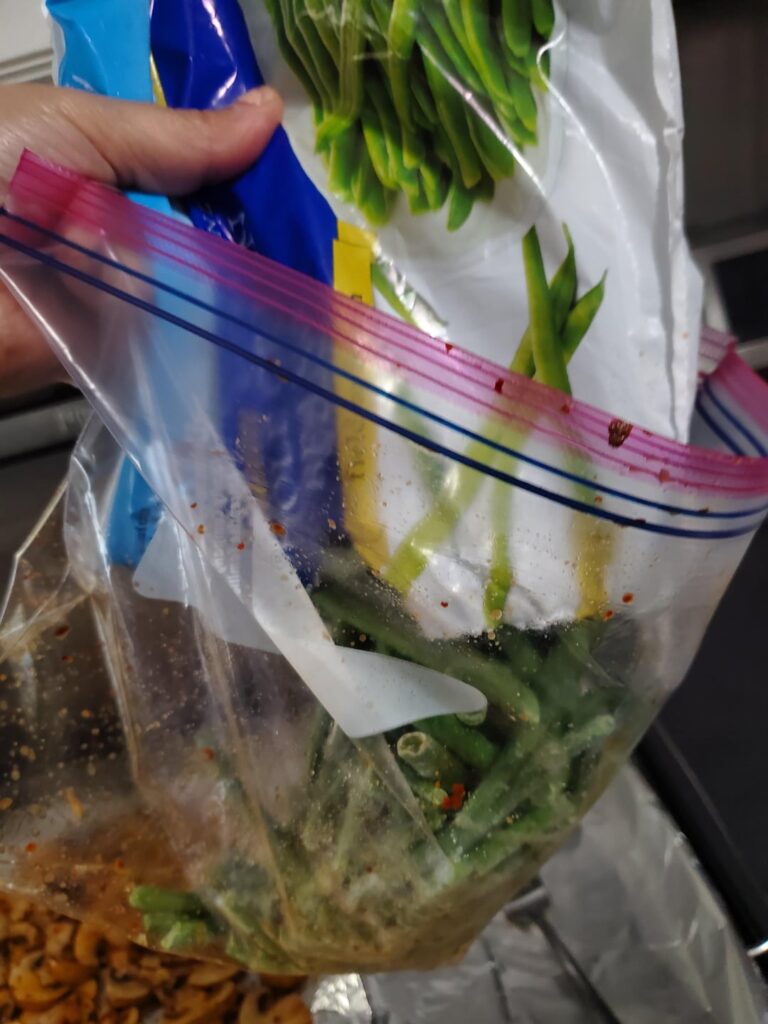 Using a ziplock bag and the "shake & bake" method to roast veggies/proteins is fast, distributes the oil/seasonings evenly and reduces clean up time. Add your desired ingredients to a large bag leaving enough room to seal and move the contents around. Then just dump and spread out on a baking tray