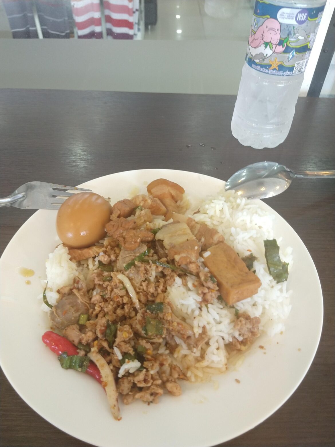 Roadside stand lunch today. 40 THB $1.28 including the water. watch out for the red chile. VERY hot. Thailand. Mango for dessert @ 20THB