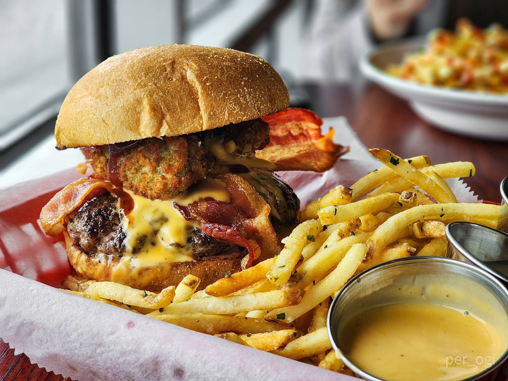 Burger w/ jalapeño poppers, beer cheese, bbq, and bacon at Table 9