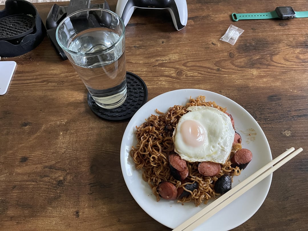 Stir fry ramen noodles with chopped hot dogs and a fried egg Dining