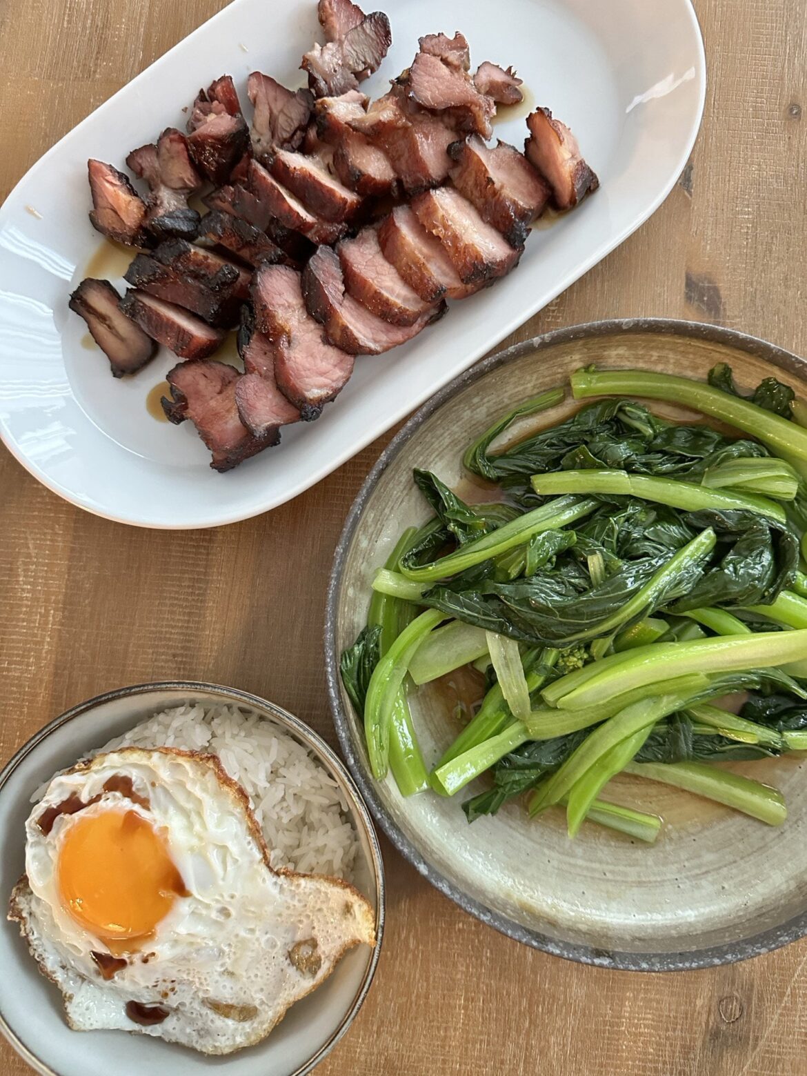 Quintessential Hong Kong comfort food: Fried egg on jasmine rice with soy sauce drizzled over it, with homemade char siu