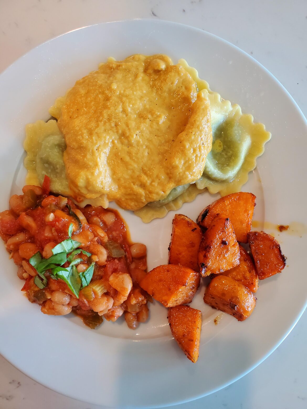 Pumpkin sauce, white beans with vegetables in tomato sauce, and Sriracha sweet potato