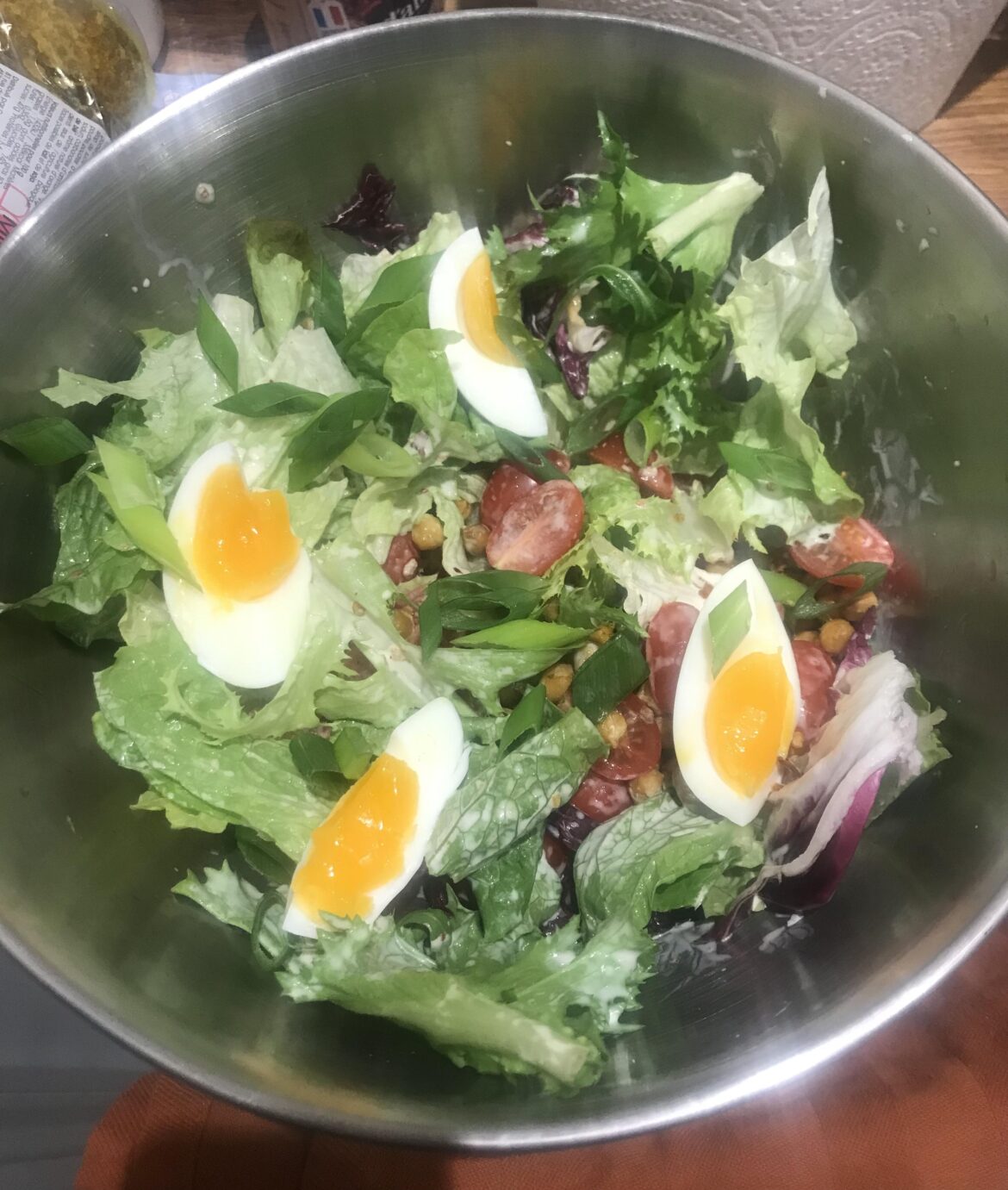 A humble salad elevated by putting an egg on it