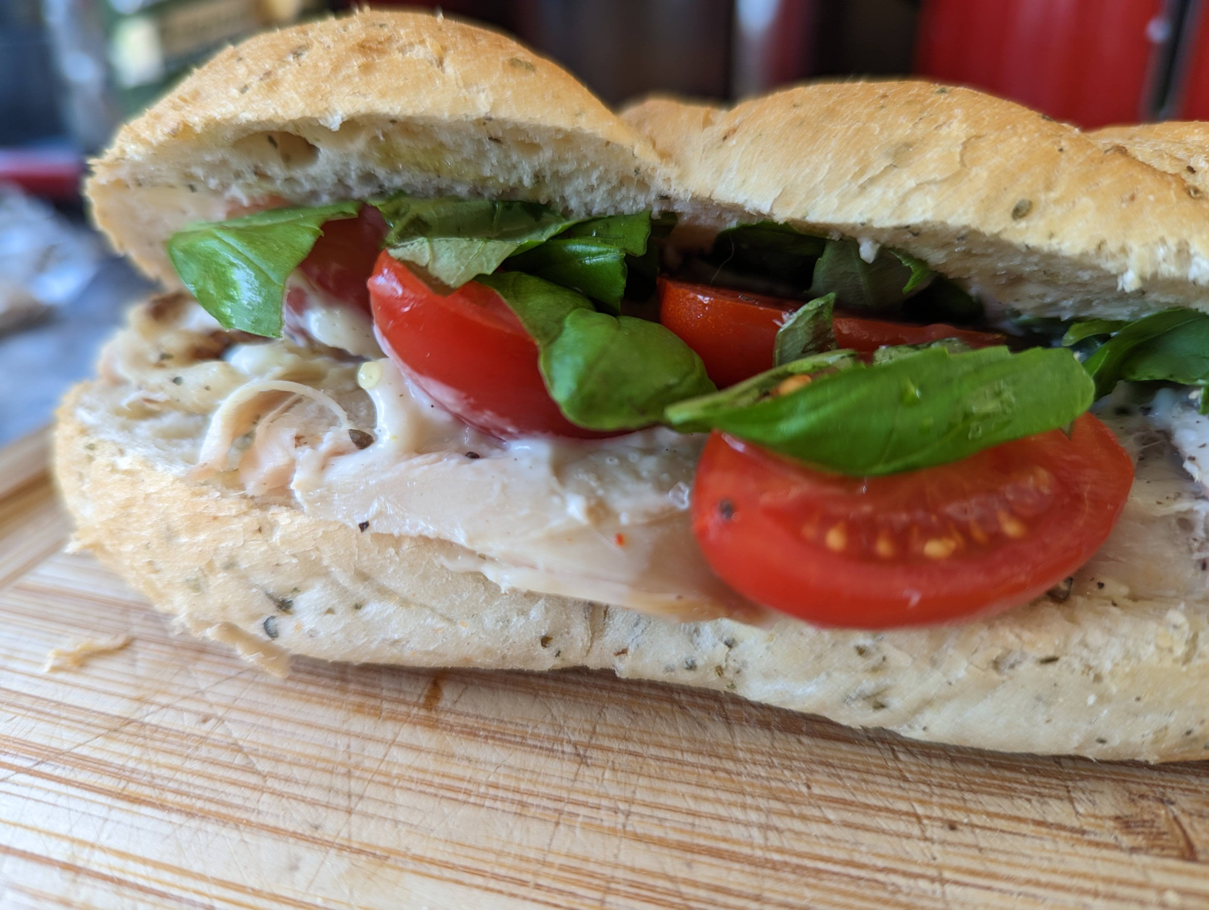 Roast chicken, tomato, aioli and fresh basil. On a cheese topped sub ...