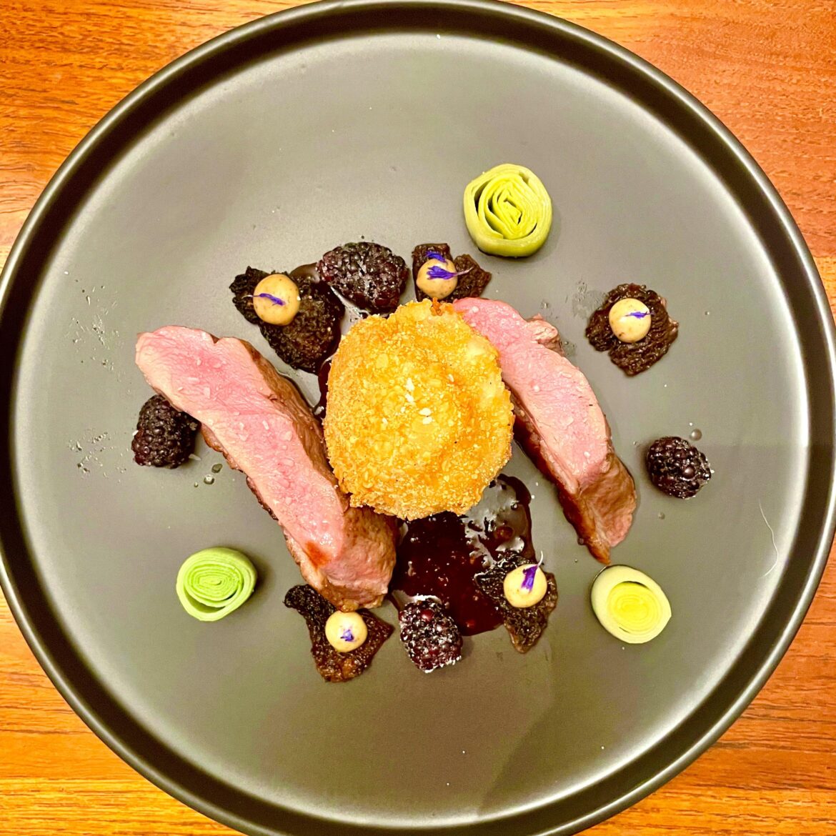 Duck, potato croquette, morels with black garlic aioli and blackberries