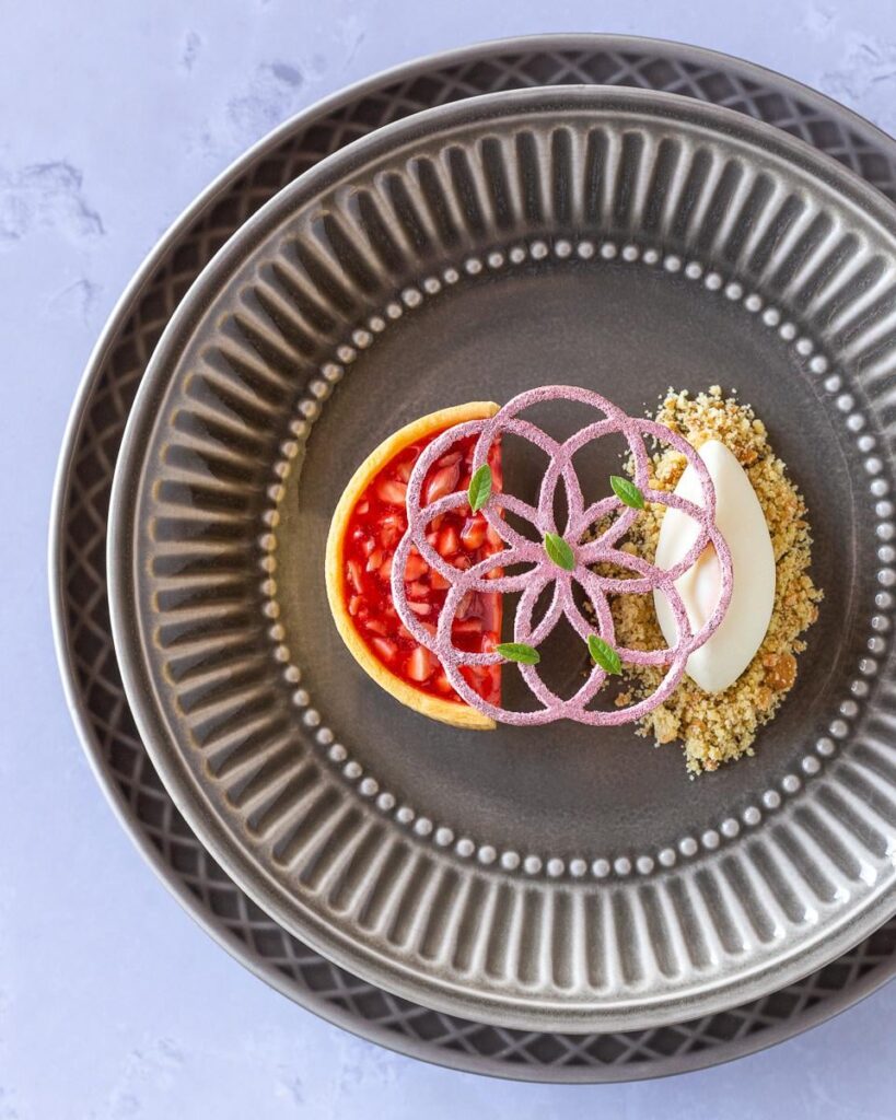 Pink Praline Tart with Orange Blossom Ice Cream, Crumble, Lemon Verbena Tuile, and Lemon Verbena Leaves