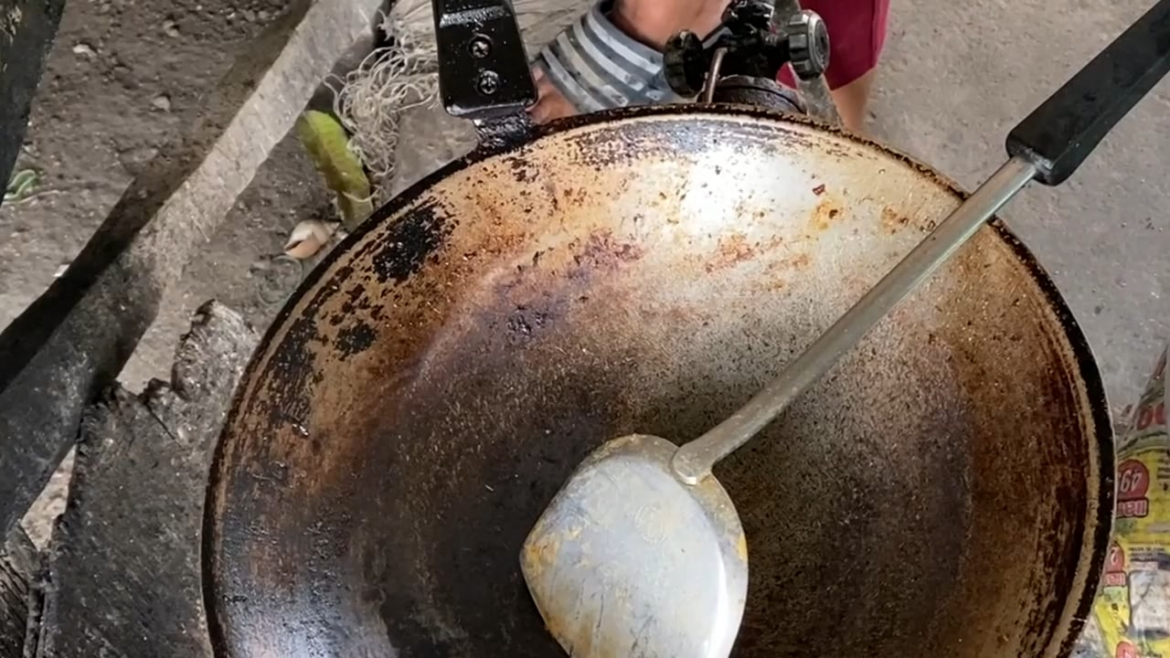 Roadside pad krapow musop kai dow in rural Thailand 45 baht