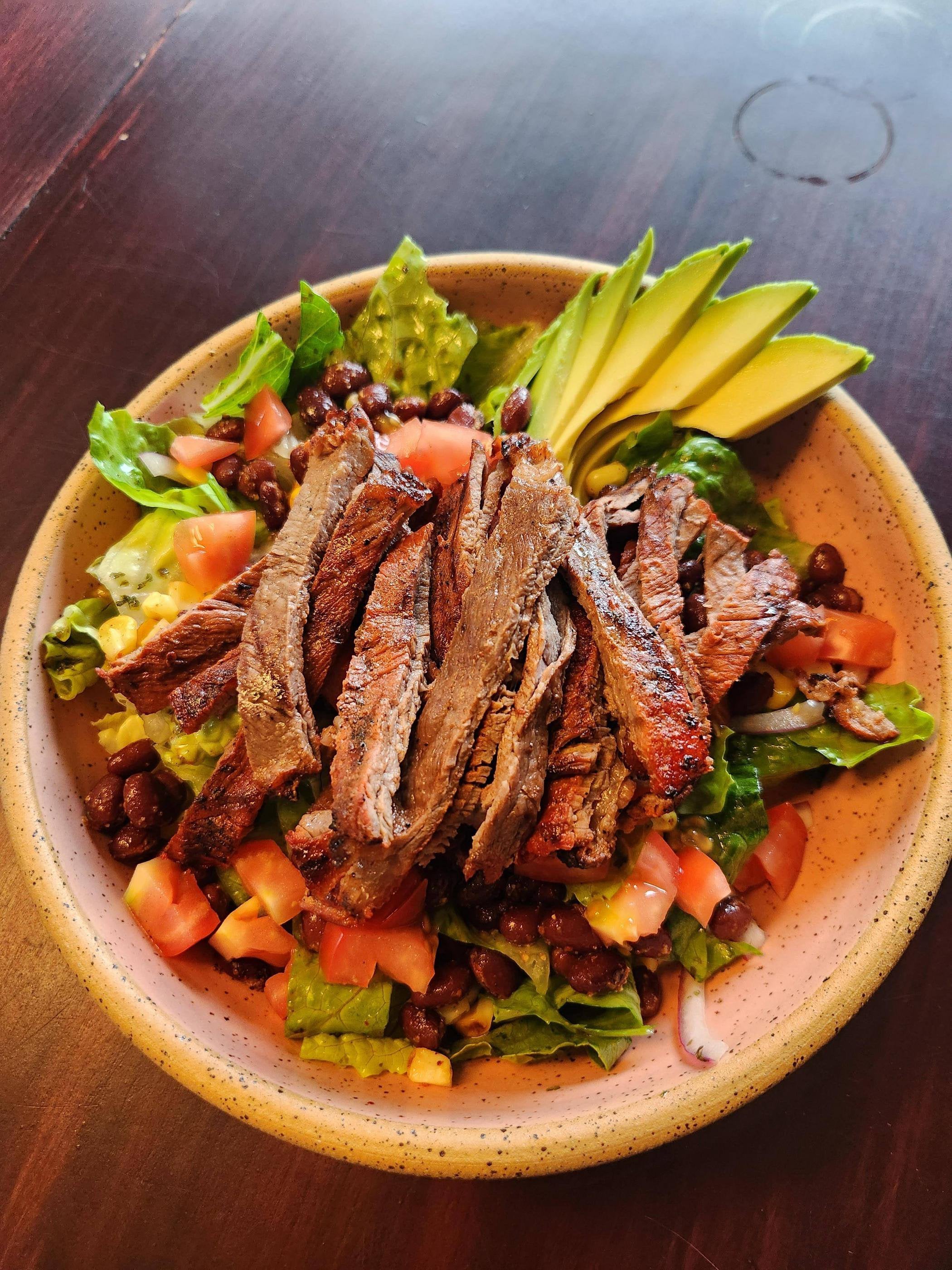 [I made] Carne asada salad with romaine, roasted corn, sessions black
