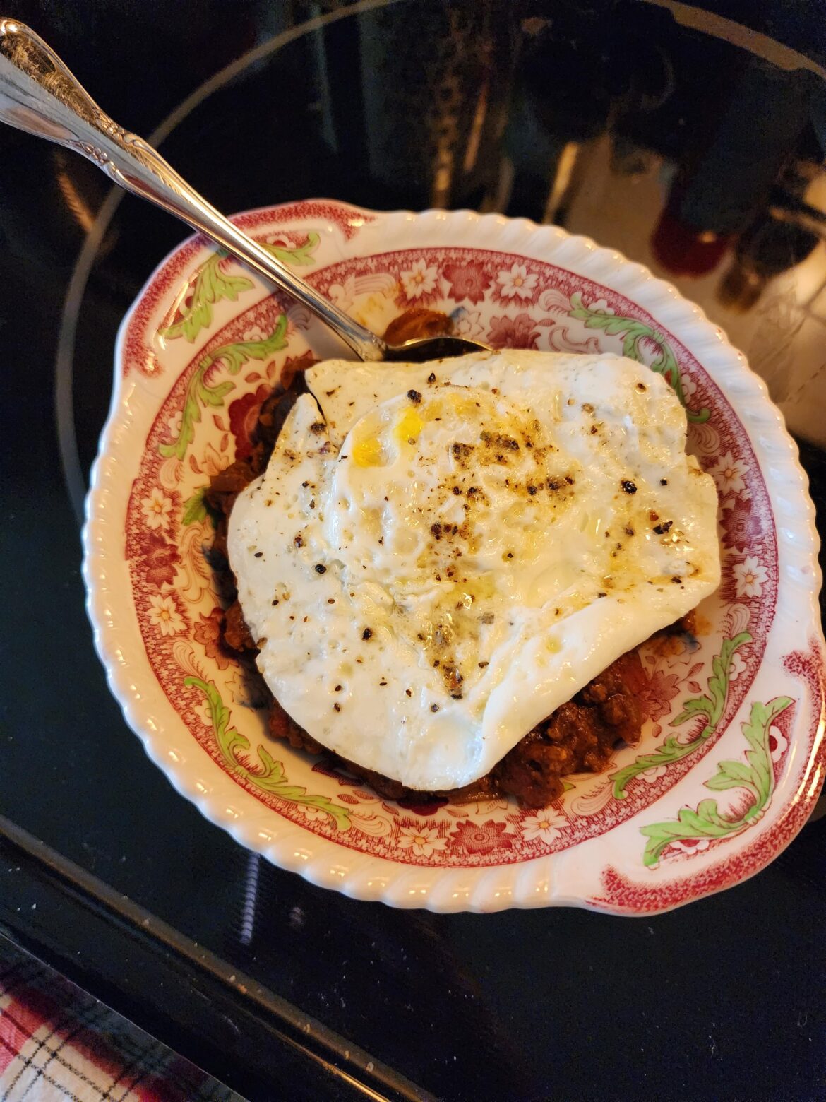 I love this combo so much! Leftover chili with black beans and an over medium egg fried in butter