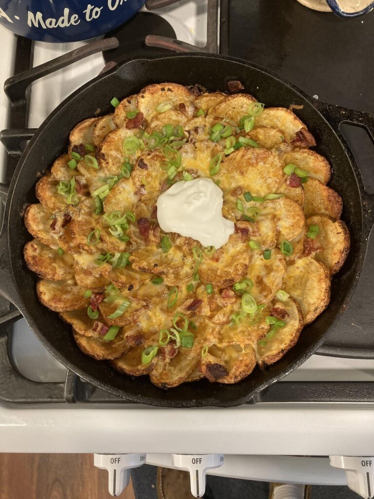 Oven roasted sliced potatoes with colby jack melted cheese, thinly sliced green onions (tops only) and a dollop of sour cream (or Greek yogurt like we did)