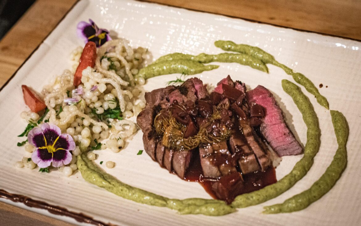 Tenderloin, spruce tip and wine reduction, couscous, pickled radish, charred leek sauce