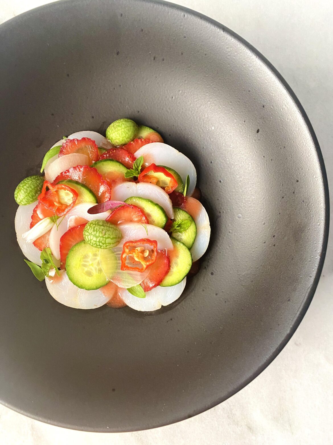 Chilled lobster, infused strawberry, cucamelon, red shishito, mini cucumber, fennel, strawberry miso dressing, and a bevy of microgreens