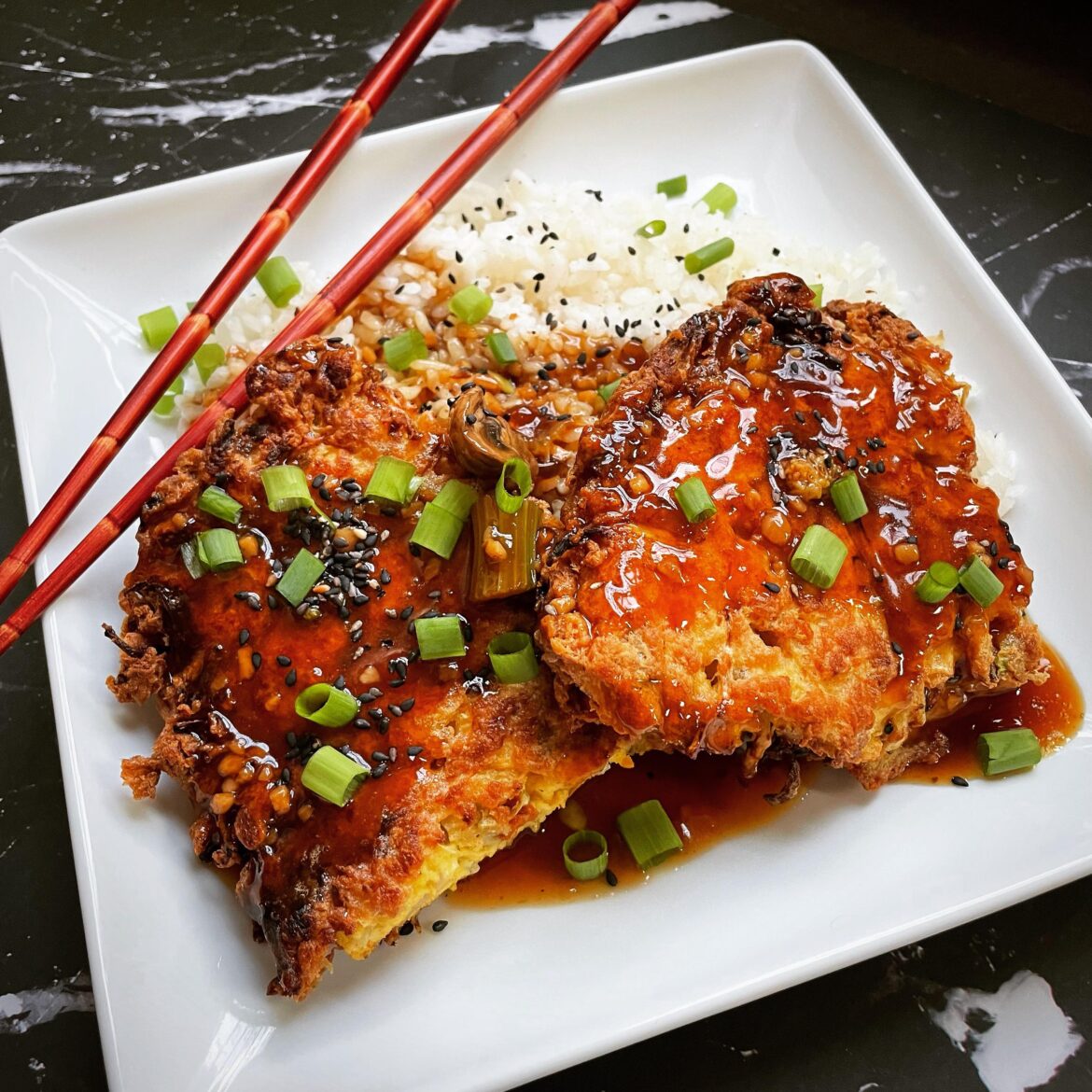 Day 1,163 of My Breakfast Project: Chinese-American Style Egg Foo Young with Bean Sprouts, Onions, Shredded Carrots, and Lap Cheong Sausage. Covered in a Savory Soy Gravy