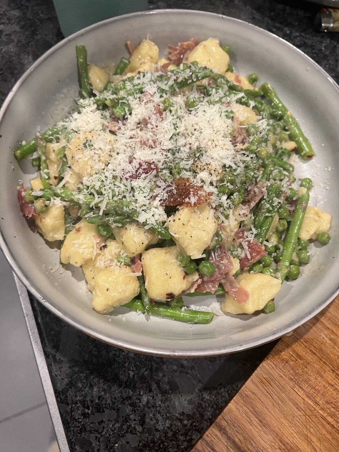 Ricotta gnocchi with peas, asparagus and prosciutto