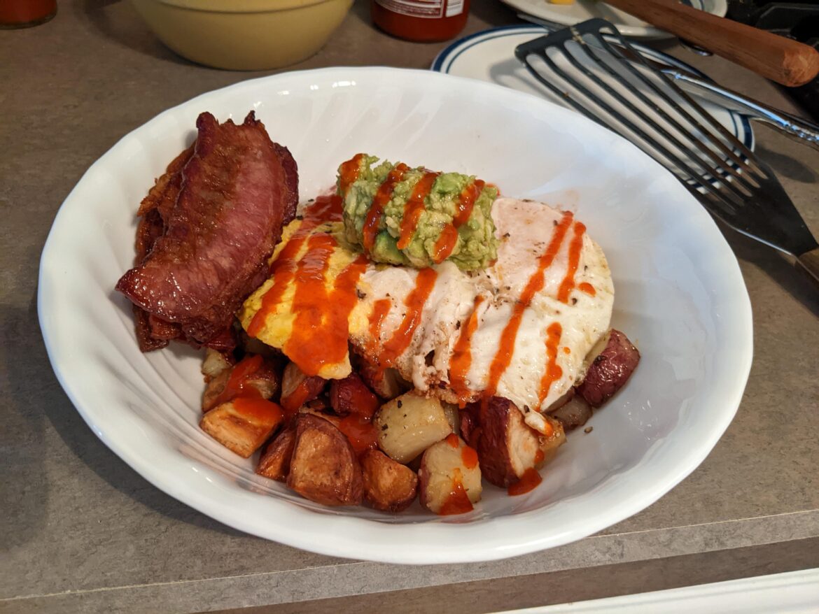 eggs, potato, bacon, avocado, and sriracha. broke one of my yokes but still posting