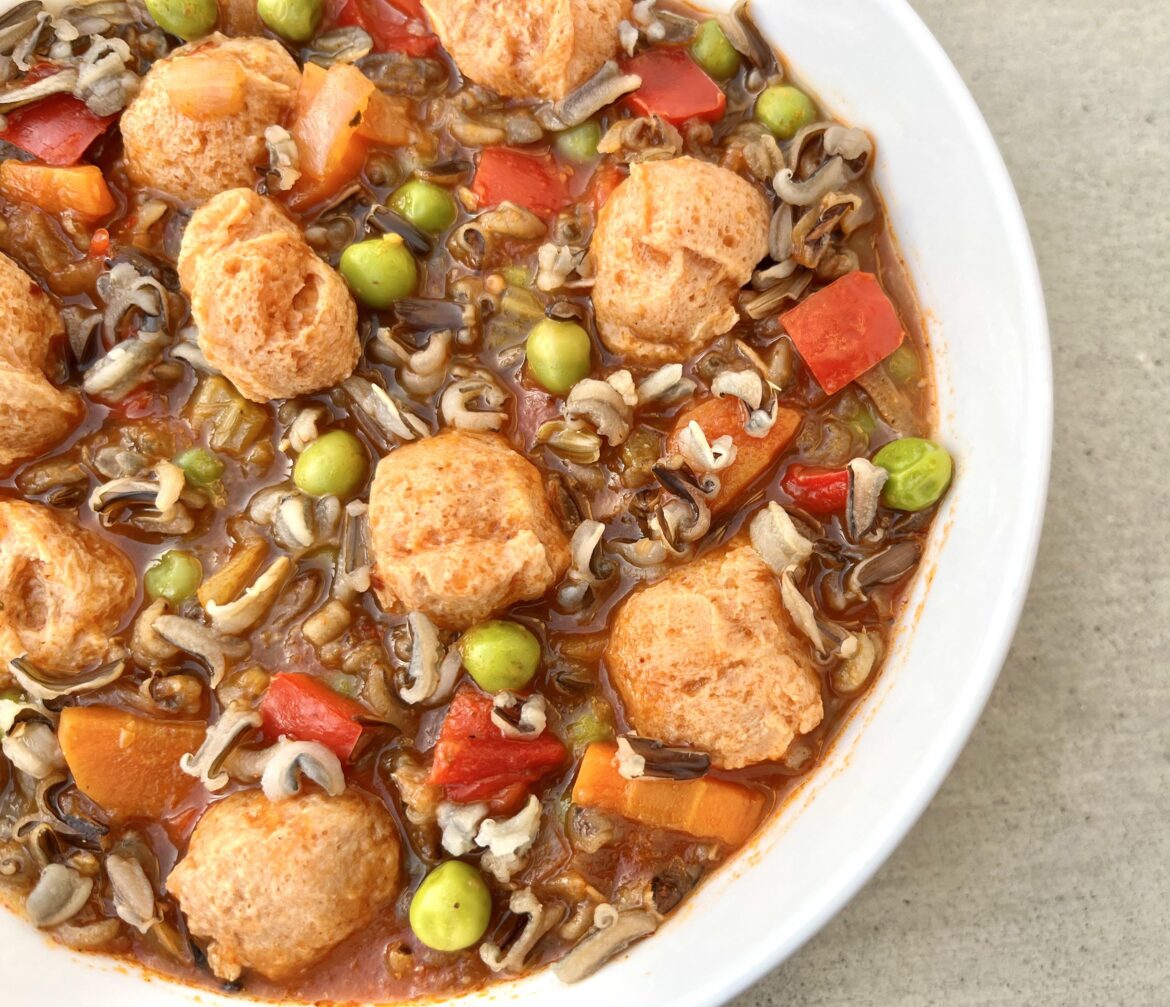 Wild rice and soy-chunk soup with carrots, peppers and peas.