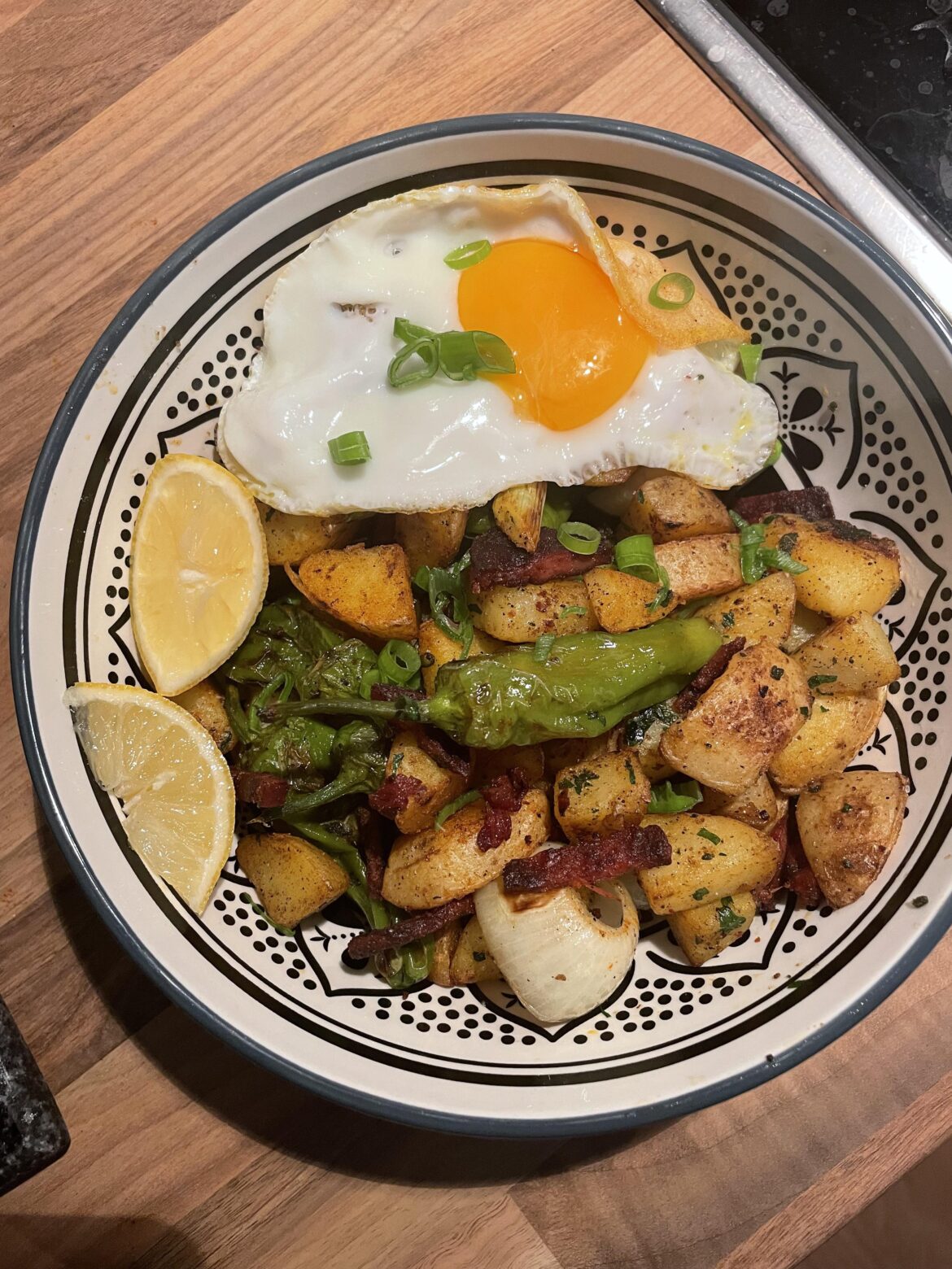 Spanish style potato bowl with chorizo and pimentos de padron