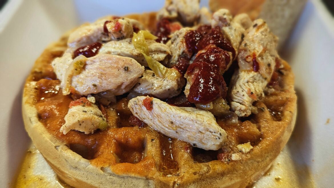 Eritrean teffi waffle with spiced chicken, tomatoes & jalapeno, topped with shiro(spiced chickpea stew) drizzled with awaze(jalapeno, onion, ginger, garlic, vinegar sauce)