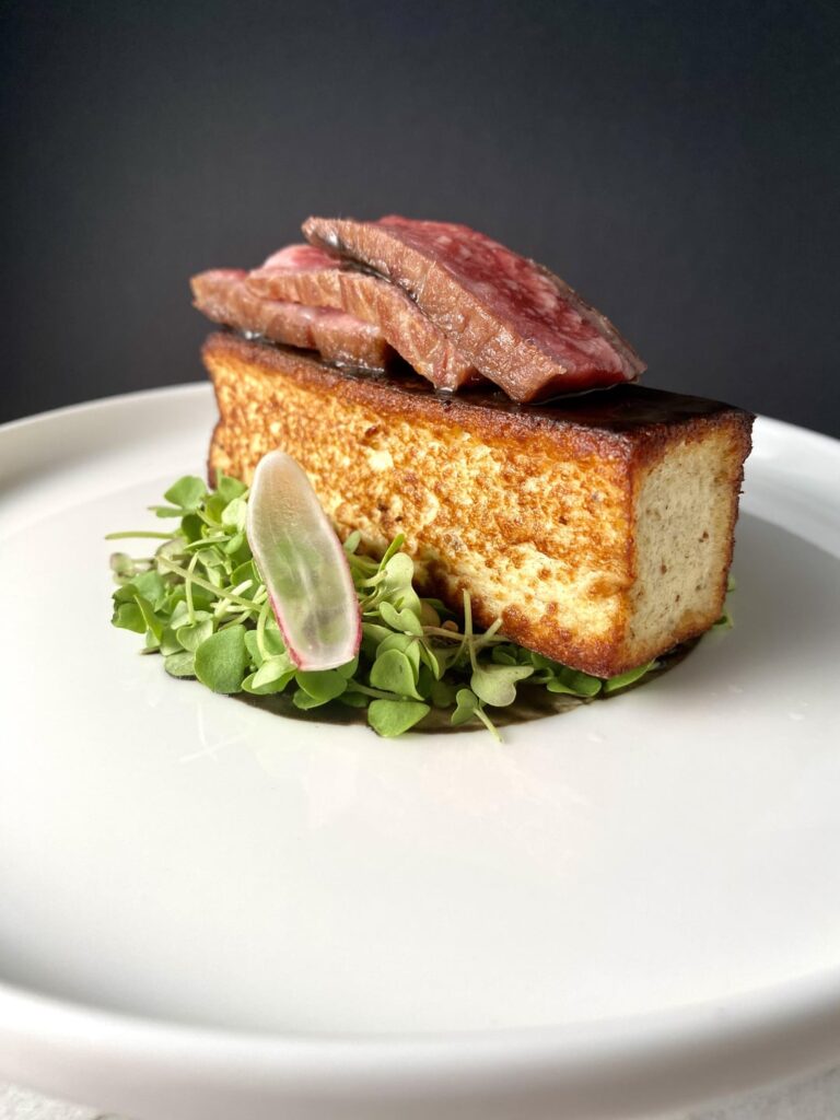 A5 wagyu, rye & goat milk budin, chanterelle & black garlic demi, wasabina, basil, french breakfast radish