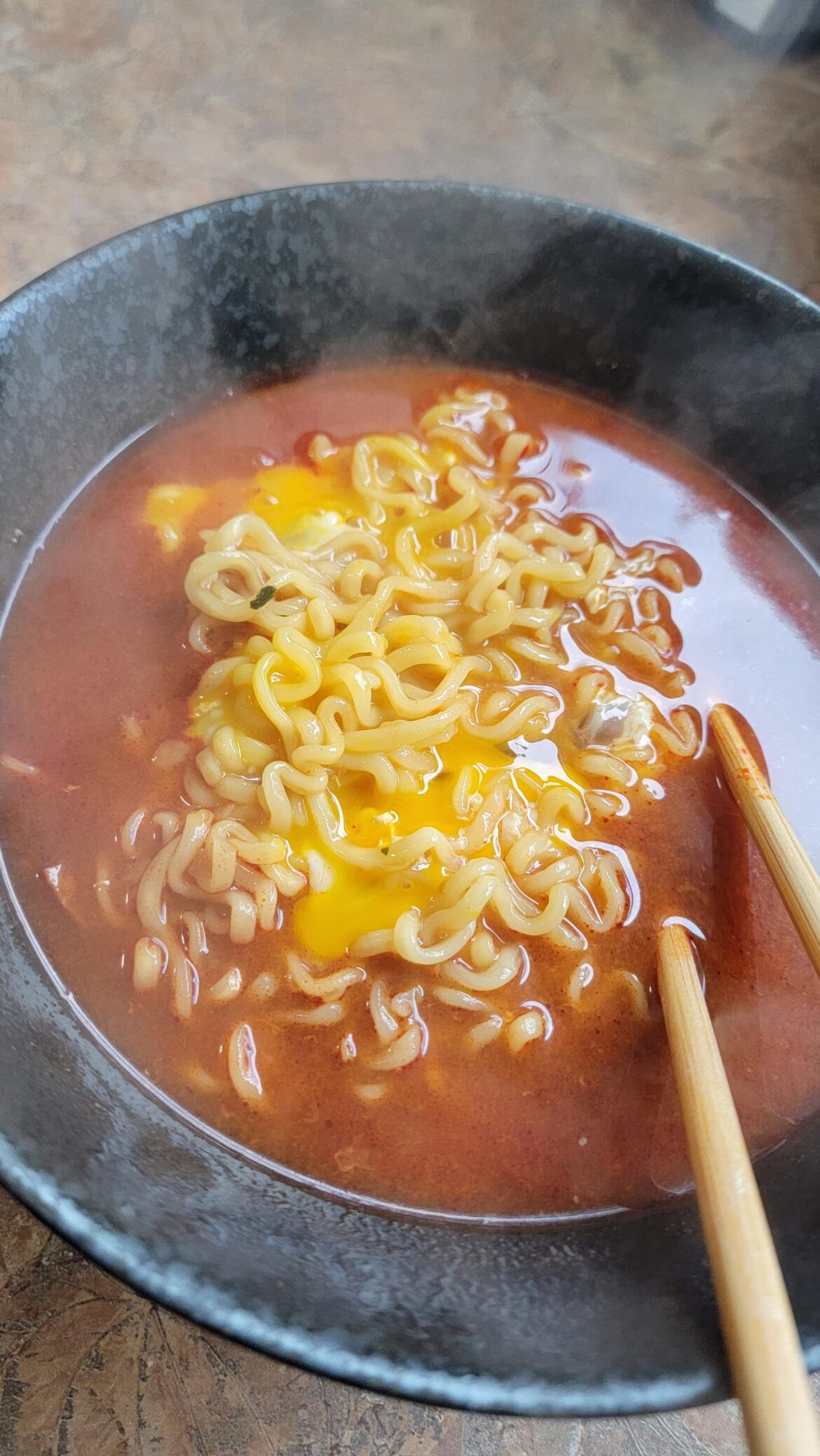 two eggs in some buldak spicy curry flavor instant ramen