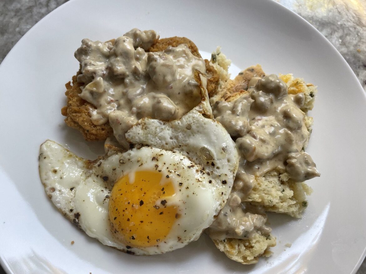 Homemade cheddar chive biscuit and homemade sausage, onion and mushroom gravy, with a store bought chicken fried steak, and yours truly.