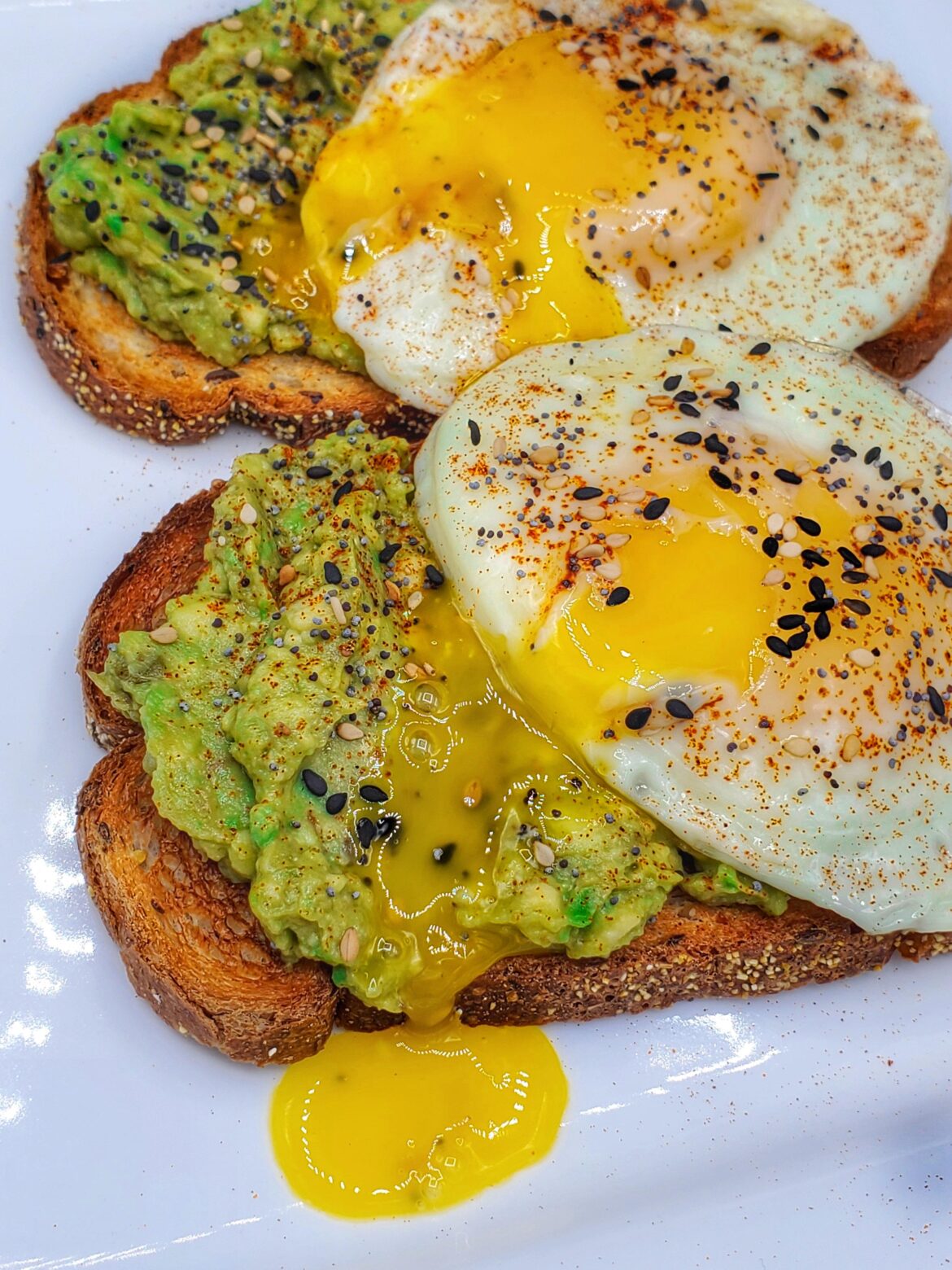 Avocado toast, eggs with Tony Chachere seasoning, white and black sesame seeds. Avacado is flavored with Sazón Tropical