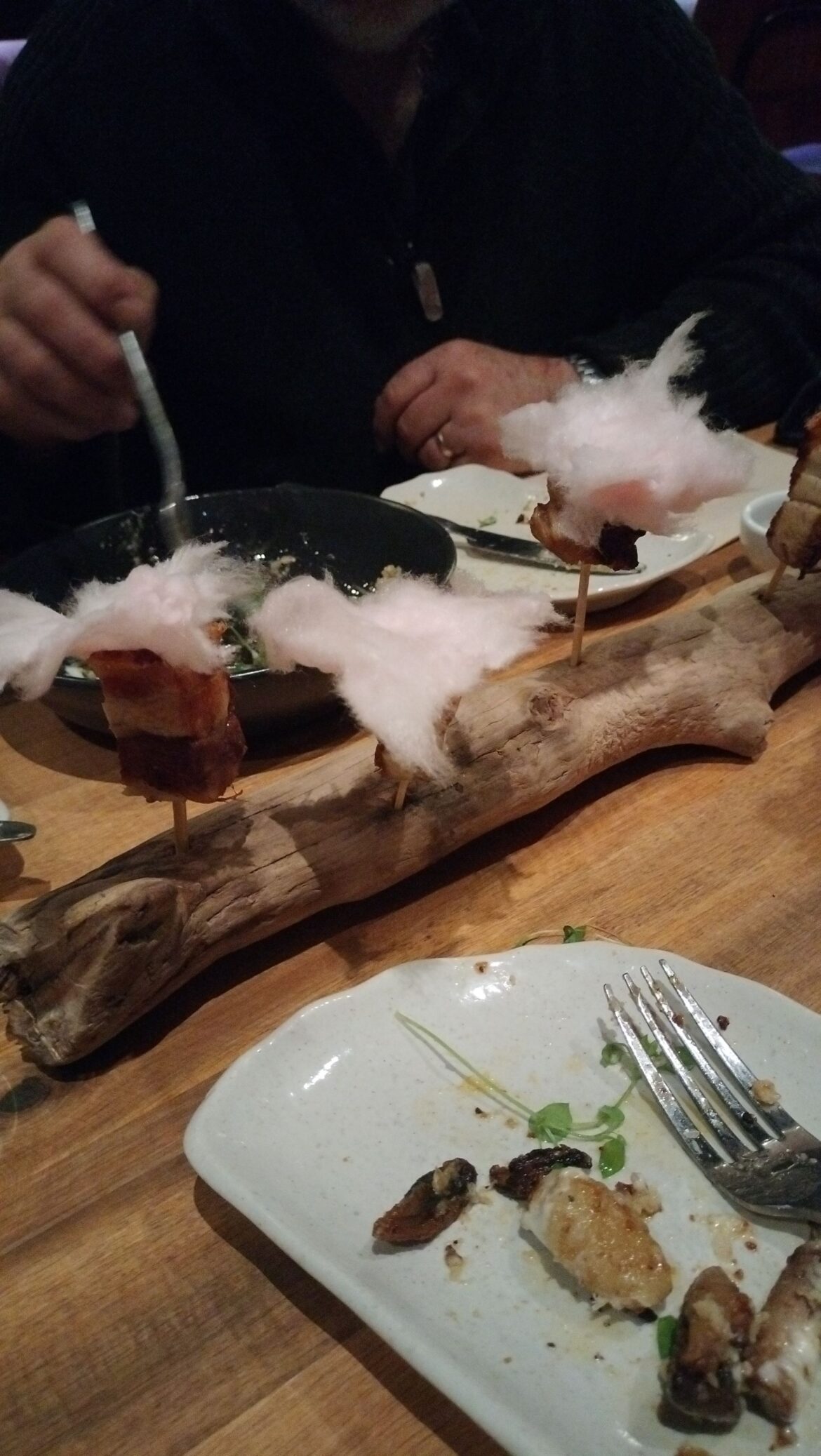 Candied pork bites served on a log