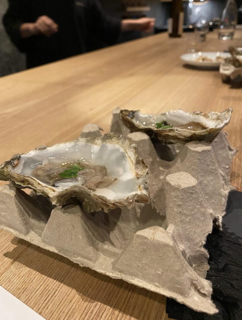Oysters served on some recycled packaging/cartons