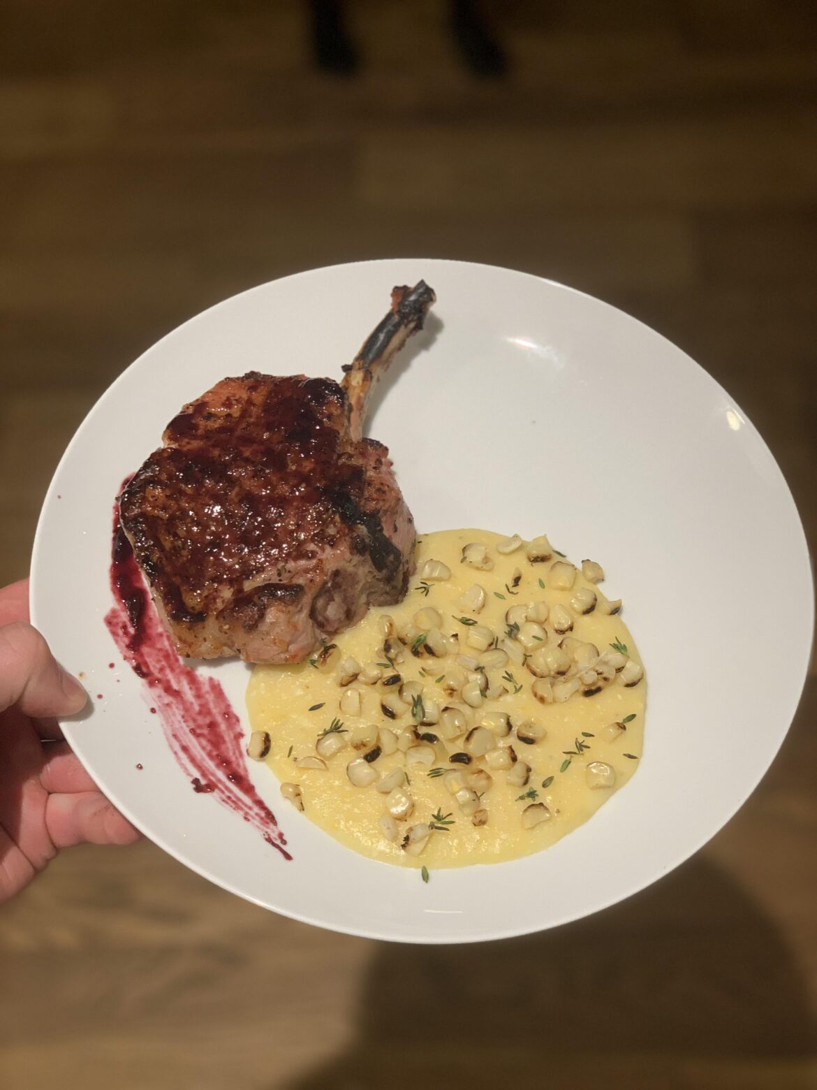 Applewood Grilled Pork Rib Chop, Blueberry BBQ Sauce, Cotija Polenta with Charred Corn and Thyme