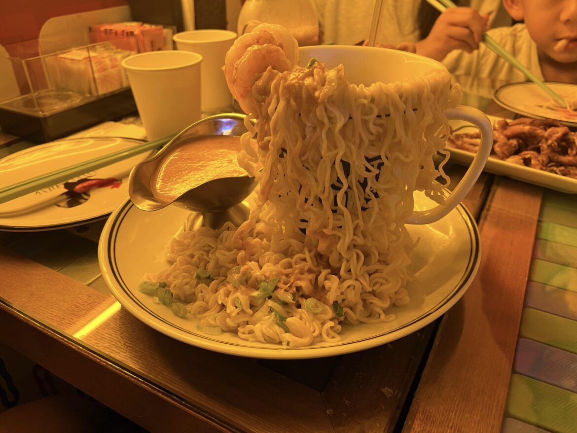 Ramen spilling out of a mug