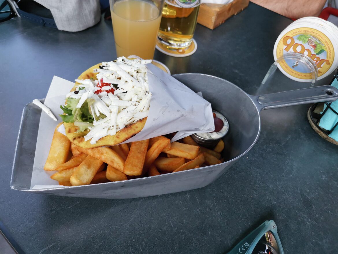 Dust pan with fries and pita