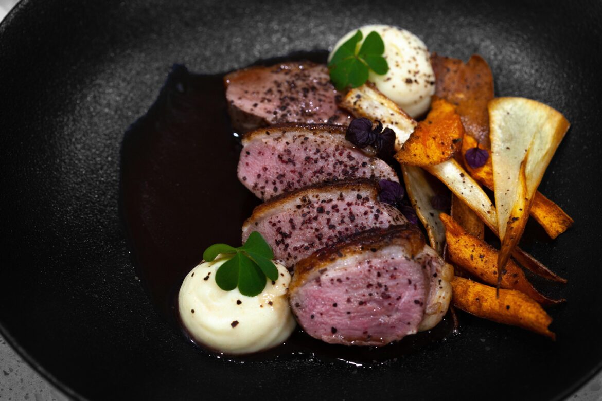 Duck, cardamom flavoured parsnip purée, carrot and parsnip chips red wine jus and a smoked onion skin salt