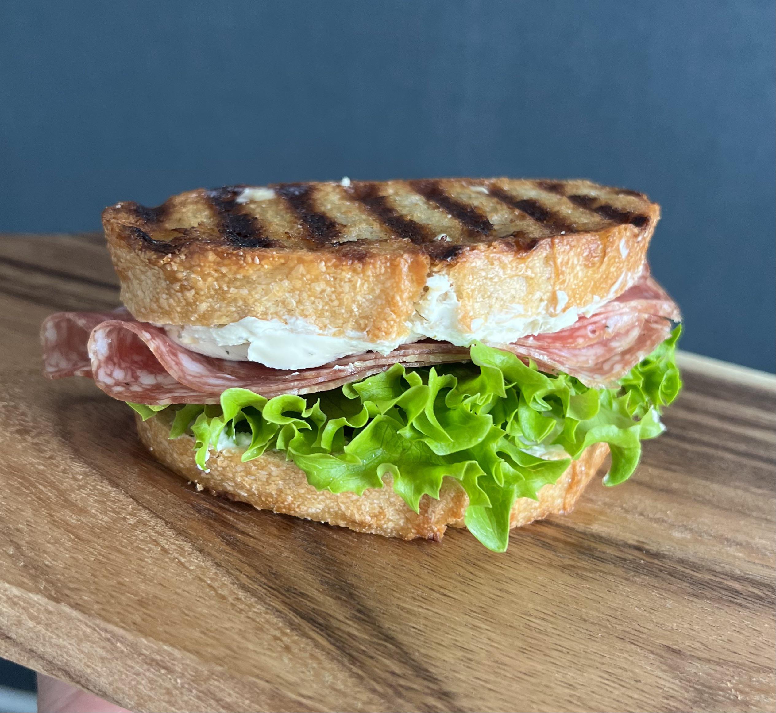 Salami Milano with cream cheese and lettuce on toasted sourdough