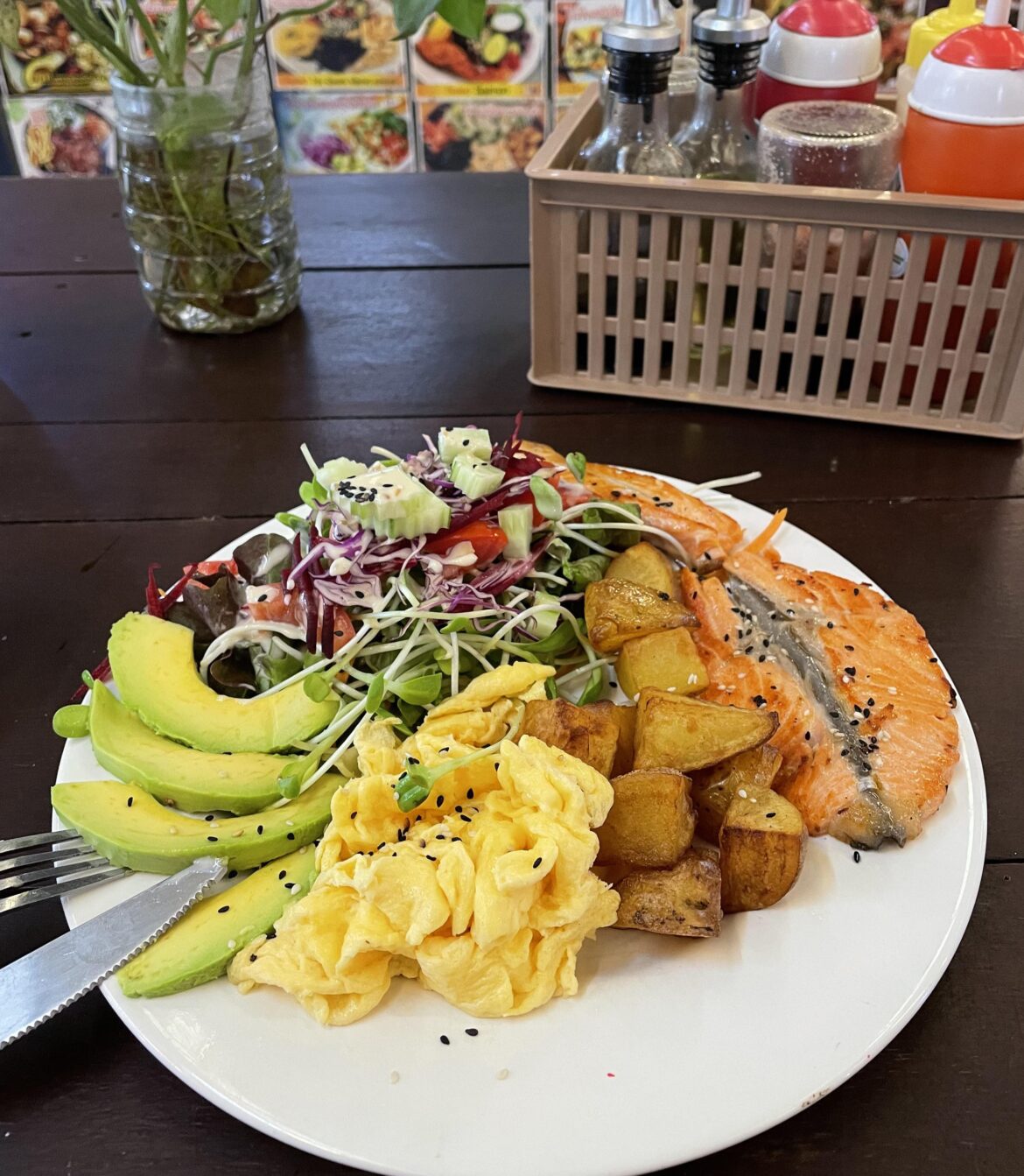 Omelette, salmon steak, avocado, baked potato and salad