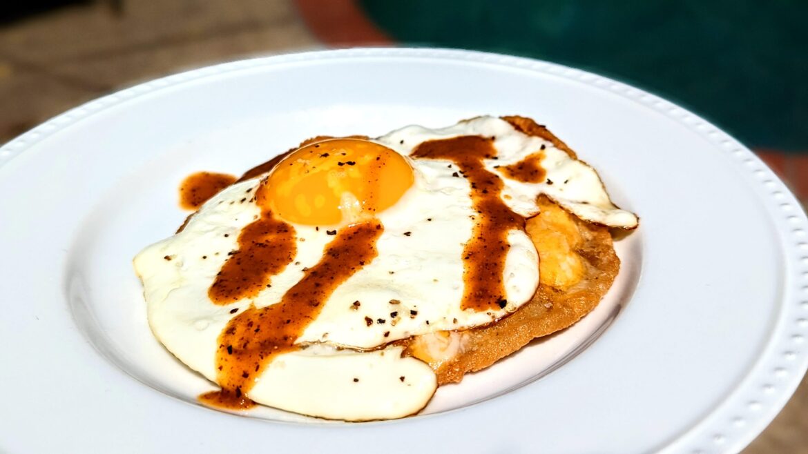 Chalupa with egg, cheese and La Perrona roasted chiltepin hot sauce