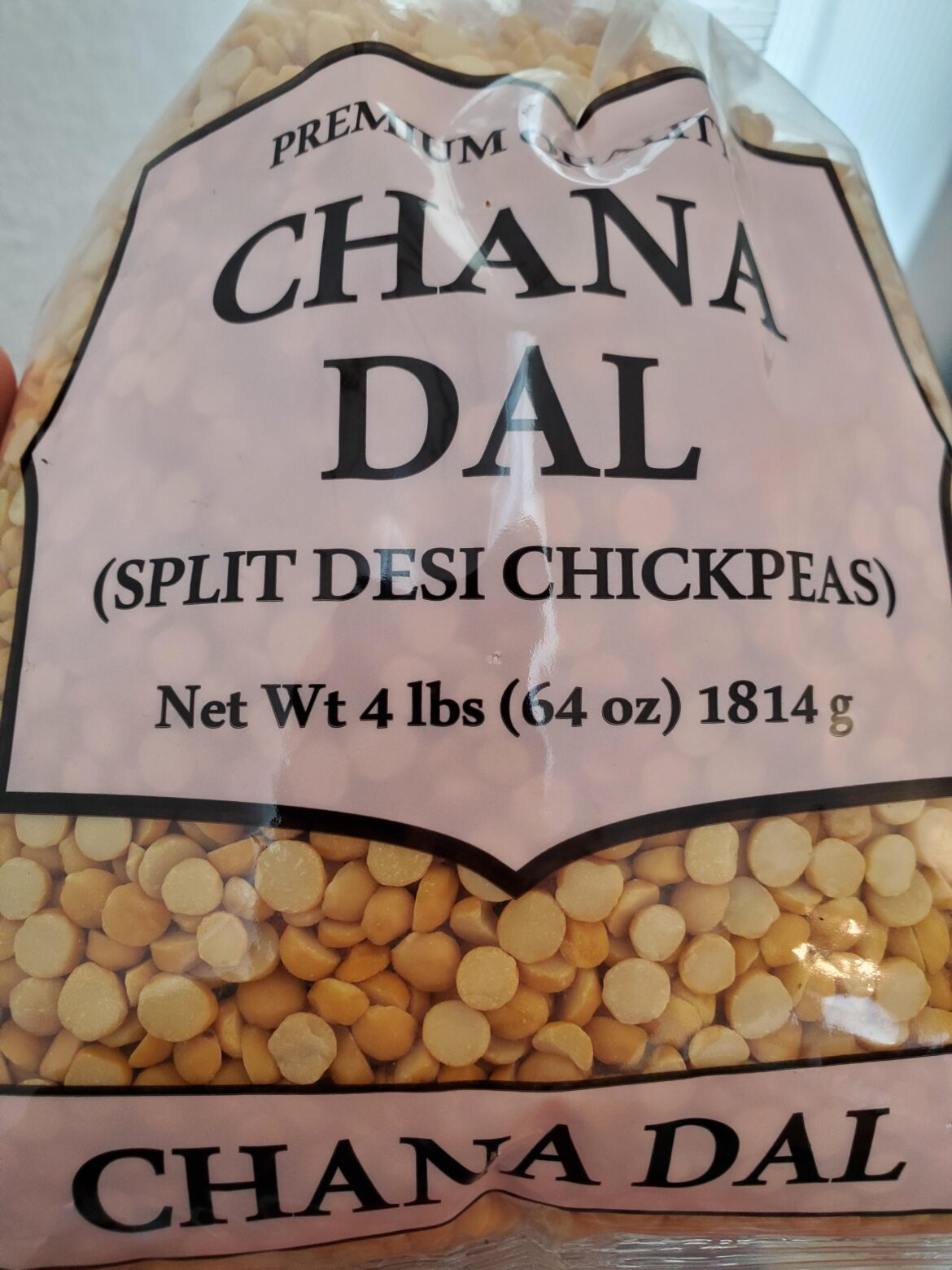 PSA: Rather than tediously peeling the skins off chickpeas, you can buy "chana dal" split chickpeas with skins already removed.