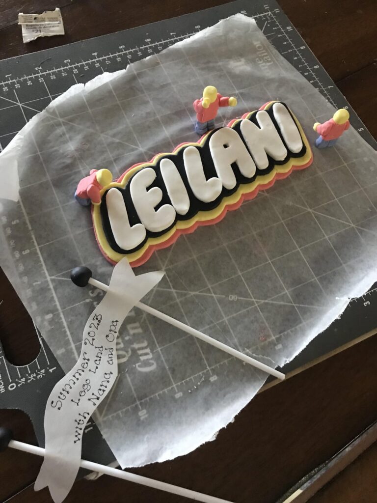 Home baker making a Lego themed cake for a coworker. Sprinkles-jointed-fondant-Lego-men have been working out their forearms lol.