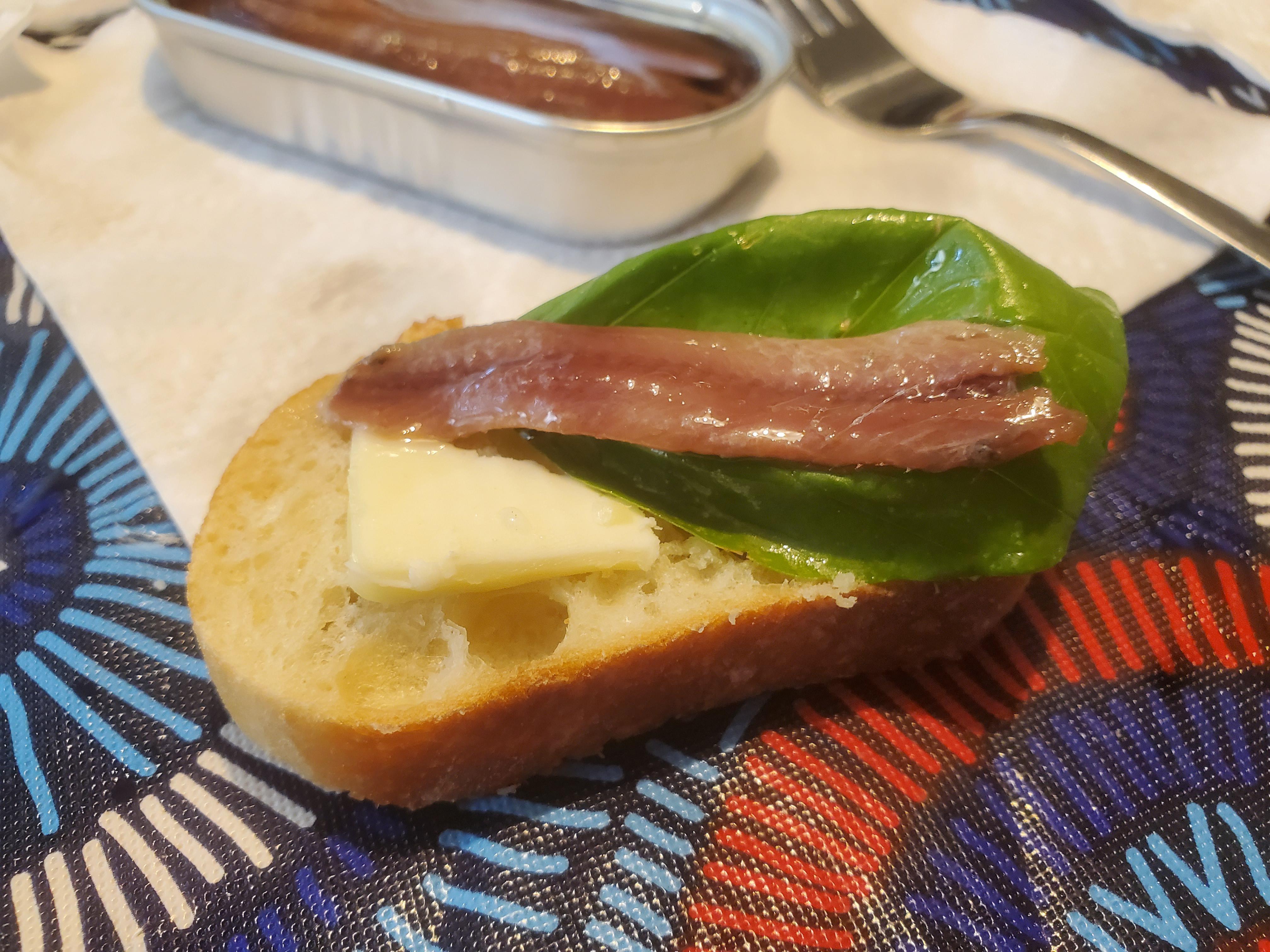 Roland Smoked Anchovies, with basil and unsalted butter, on baguette