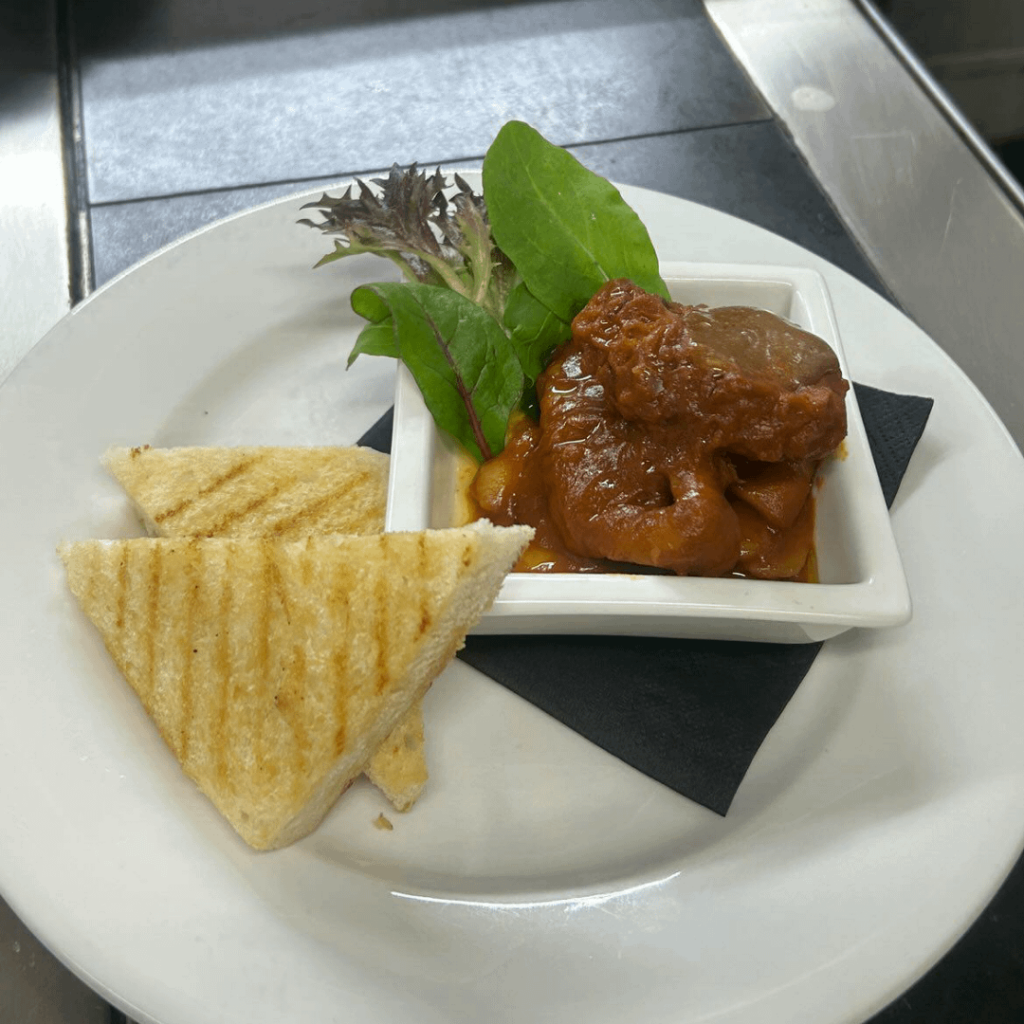 Braised octopus. Black garlic mayonnaise. Toast. Greens.