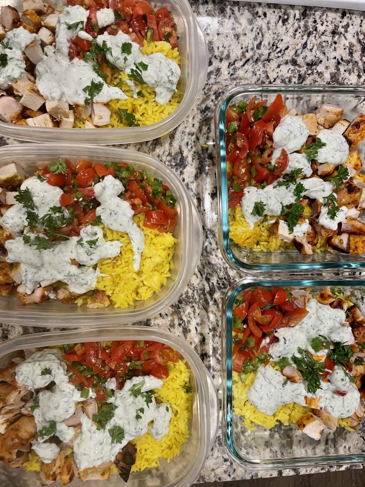 Chicken gyro bowls on saffron rice with spicy salad side and tzatziki garnish