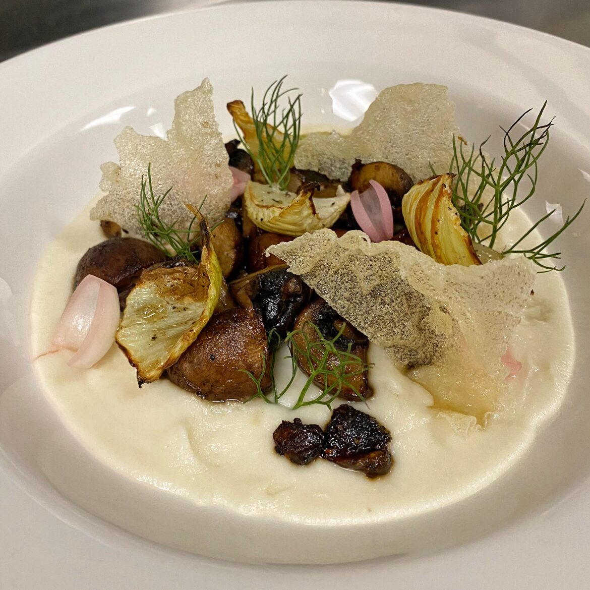 Mushroom Adobo. Filipino-style adobo glazed Cremini, celeriac purée, roasted fennel, pickled pearl onions, puffed rice paper.