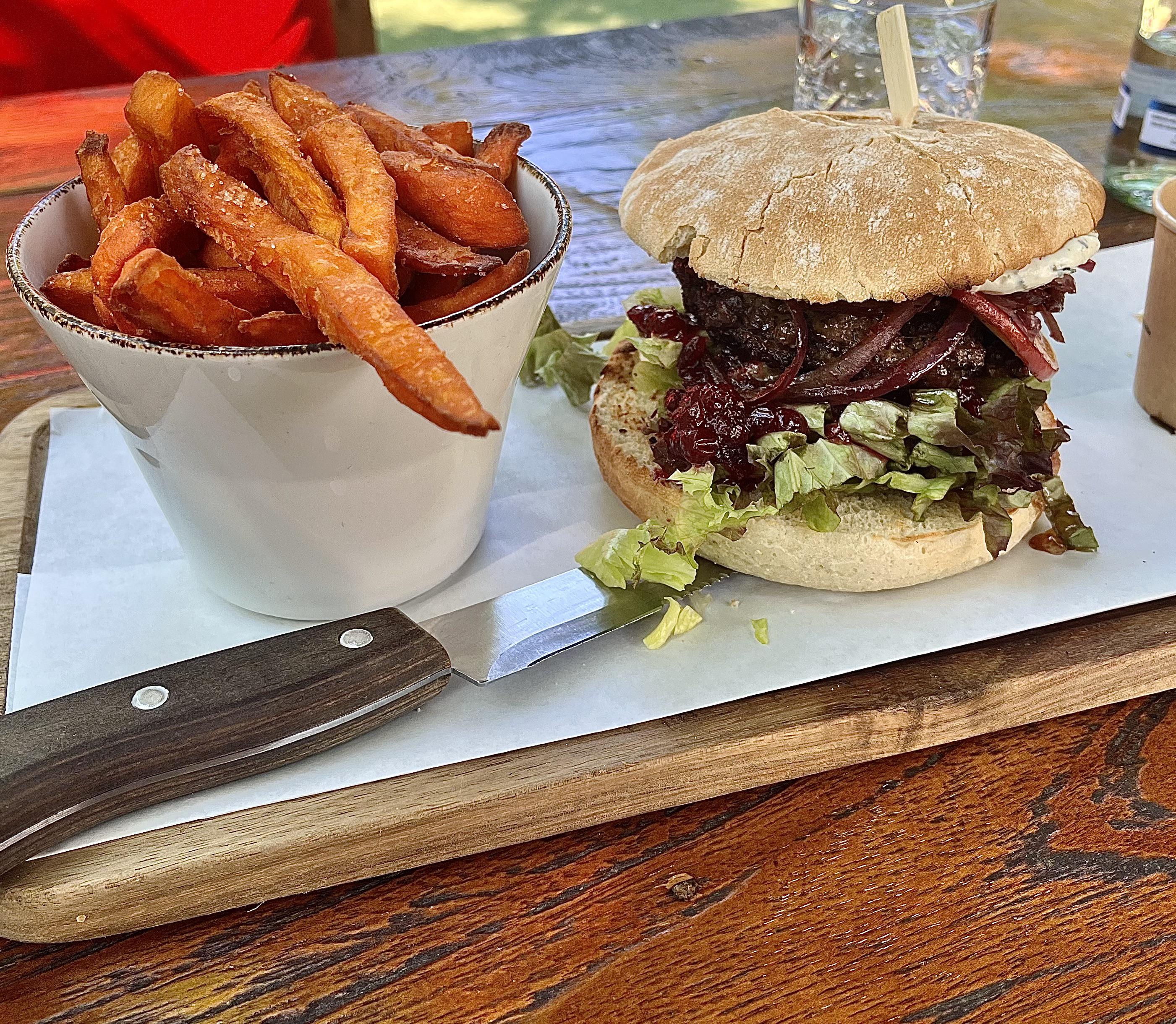 Venison Burger with roasted red onions, apple slices and wild cranberry