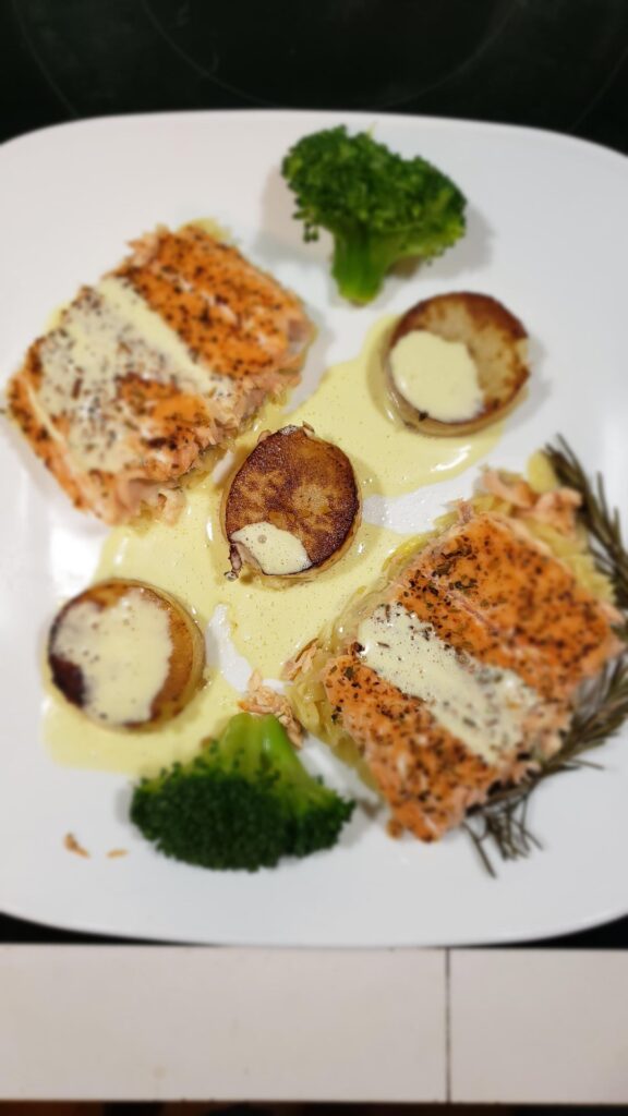 Pan seared salmon over rosemary orzo, fondant potatoes and steamed broccoli with bearinaise sauce