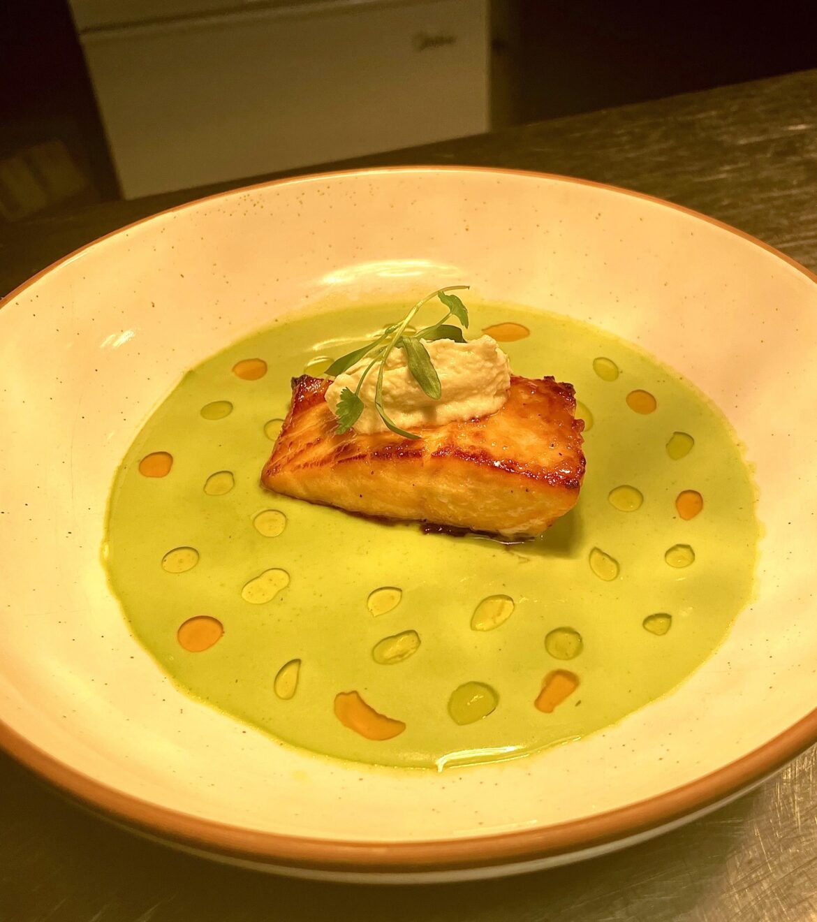 honey seared salmon on pea cilantro emulsion with yuzu kosho & fennel mousse
