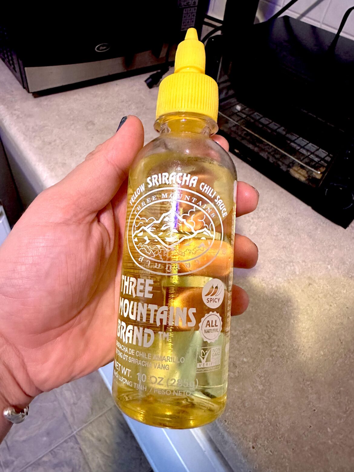 Use empty sriracha containers as twist top cooking oil dispensers