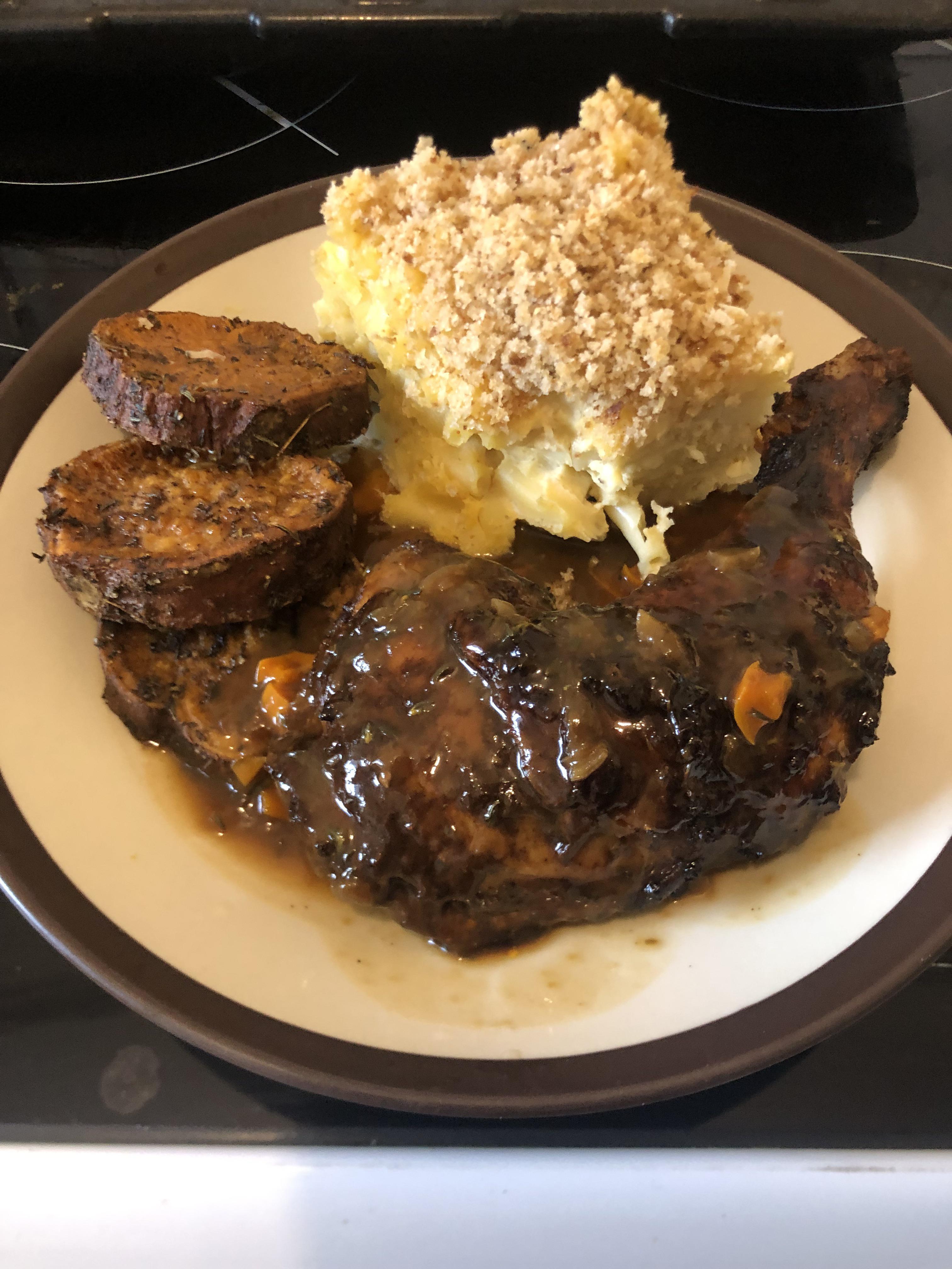 Homemade jerk chicken macaroni cheese with baked sweet potatoes and a