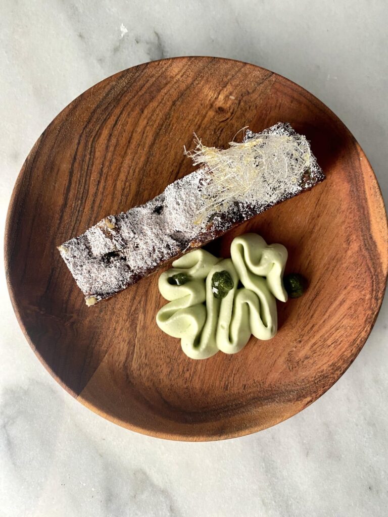 Crispy pasilla brioche bread pudding, cinnamon orange wash, sweet oregano crème fraîche, arbol caramel spun sugar, oregano gel