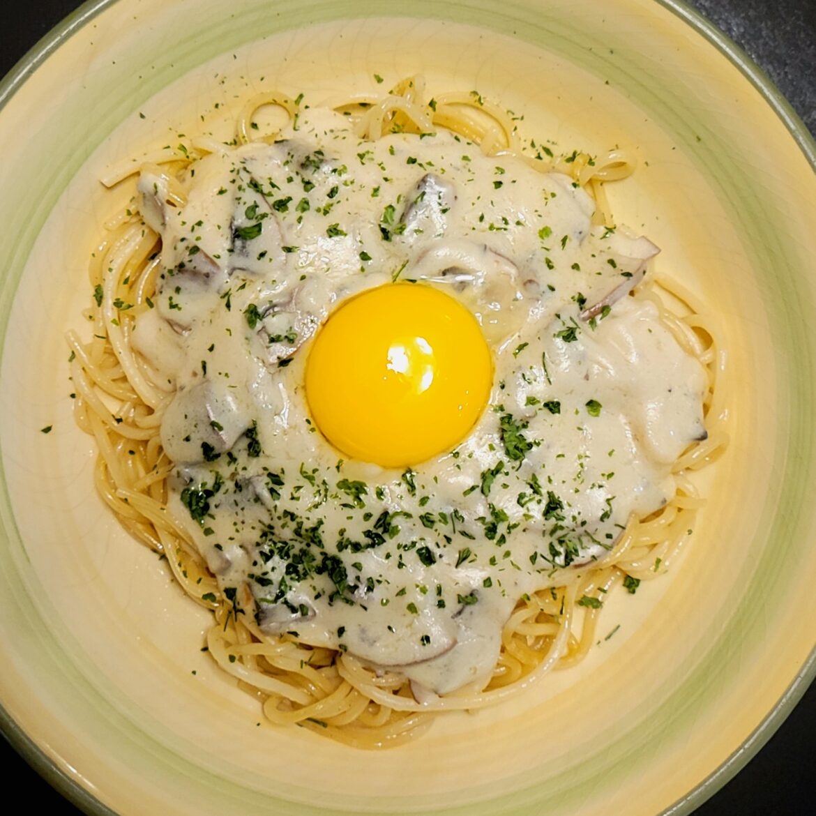 Homemade Mushroom White Sauce over Pasta, topped with an Egg Yoke!