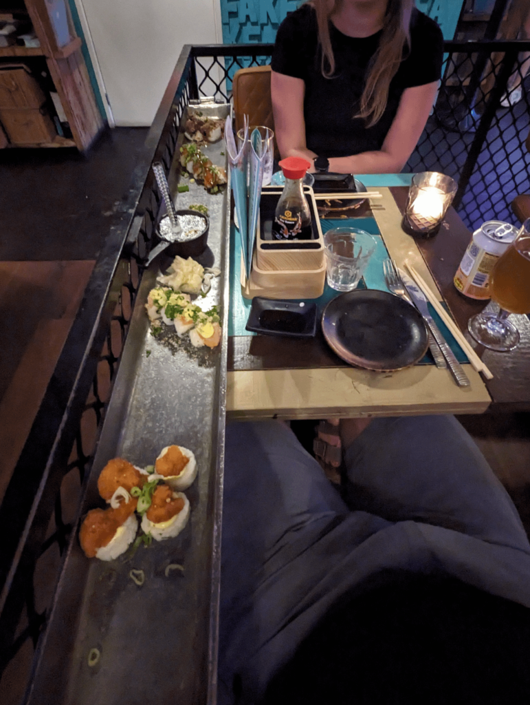 a board twice as long as the table, for 16 pieces of sushi...